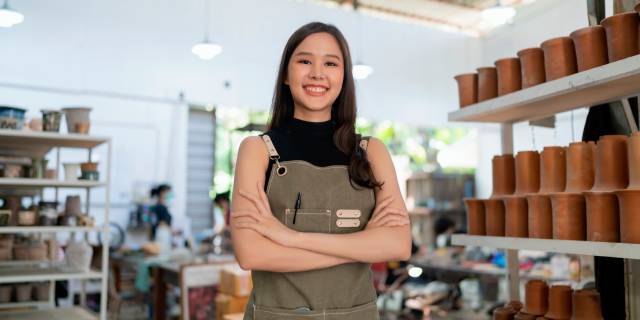 asia-female-ceramist-with-apron-hand-confident-chest-her-workshop-clay-sculpture-studio-with-positive-smiling-warm-welcome-ready-start-new-factory-ceramic-workshop-with-new-collection-work-1.jpg