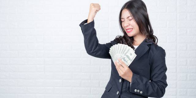 business-woman-holding-banknote-cash-separately-white-brick-wall-made-gestures-with-sign-language-1.jpg