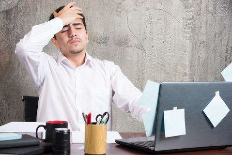 businessman-having-headache-office-desk-1.jpg
